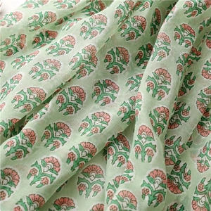 Detailed macro view of mint green cotton scarf featuring vintage floral and leaf patterns