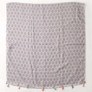 Detail of blue cotton linen scarf with orange flower prints and fringe tassels