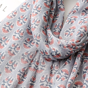 Close-up of grey cotton linen scarf featuring detailed ethnic floral print and texture