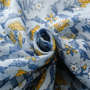 Detailed texture of cotton linen scarf with blue yellow floral print and elegant drapes