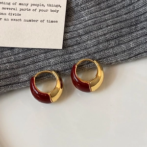 U-shaped red enamel and gold-plated earrings with bold contrast on white display