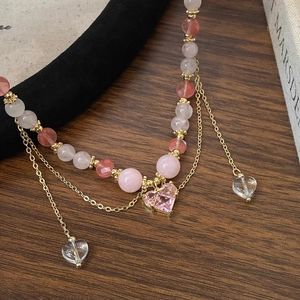 Beaded colorful natural stone necklace with a pink heart pendant and gold metal accents
