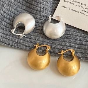 Chic gold and silver brushed metal C-shape hoop earrings with a matte texture