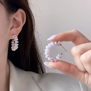 Elegant C-shaped hoop earrings featuring iridescent purple baroque pearls for women