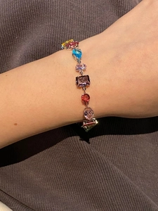 Close-up of rainbow crystal bracelet with multi-color stones in various geometric cuts