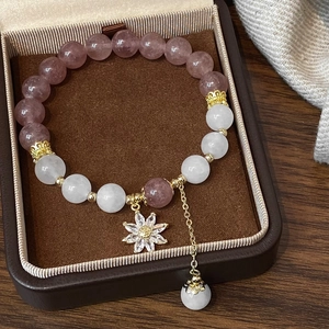 Strawberry and white quartz beaded bracelet with star pendant on a gift box