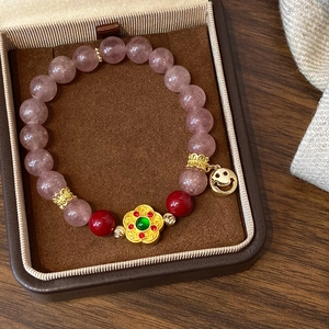 Pink natural stone beaded bracelet with golden flower charm and smile pendant in jewelry box