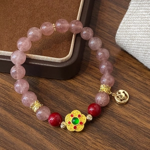 Pink natural stone beaded bracelet with golden flower charm and smiley face pendant