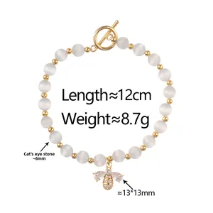 Detail of bee pendant on cat's eye stone bracelet with gold OT clasp closure