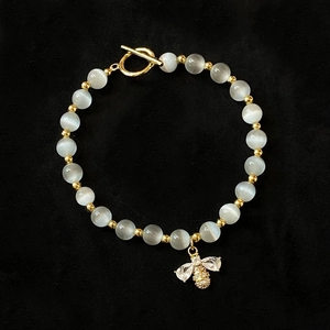 Cat's eye stone beaded bracelet with golden bee pendant and toggle clasp closure