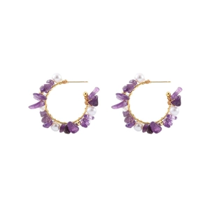 Bohemian gold C-shape earrings featuring purple stones and white pearls on white background