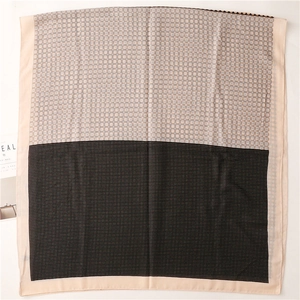 Detail of contrast stitching scarf with geometric patterns and lightweight cotton feel