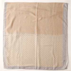 Detailed top view of a grey bordered scarf with orange and green clover star patterns