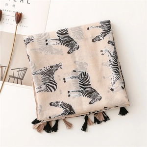 Detail of apricot zebra print scarf with dual-color tassel fringe and linen texture