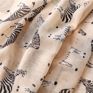 Close-up of zebra print scarf showing lightweight linen texture and soft beige fabric draping