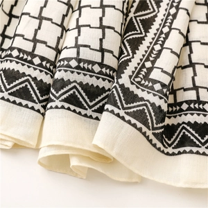 Detailed close-up of British plaid scarf fabric showing weave texture and geometric patterns