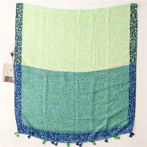 Detail of floral paisley print on lightweight linen-feel shawl with tassel fringe