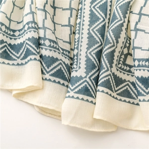Detailed macro view of woven fabric texture with ethnic geometric patterns on a soft shawl