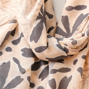 Macro detail of breathable cotton-linen scarf featuring elegant abstract grey petal prints