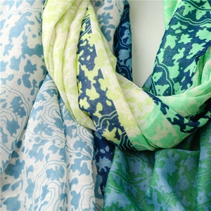 Detail of multi-color floral print on lightweight linen-feel scarf with fine fabric texture