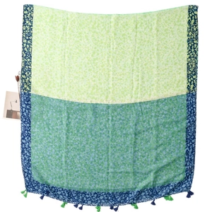 Green and teal floral linen-feel shawl with colorful vine patterns and fringed tassels