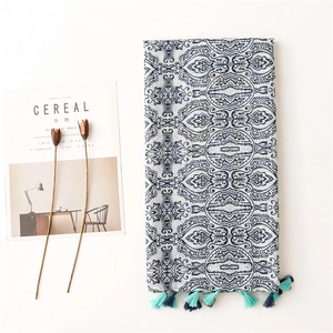 Bohemian paisley print oversized scarf with blue fringes on a clean minimalist background