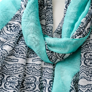 Macro detail of bohemian paisley print scarf showing soft cotton-linen texture and blue patterns