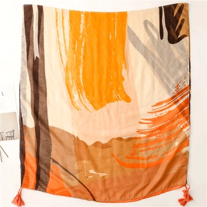 Detailed view of sunset orange abstract art print scarf with handmade tassels
