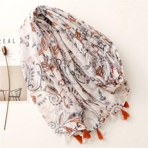 Elegant white paisley print scarf with orange tassels on a minimalist background