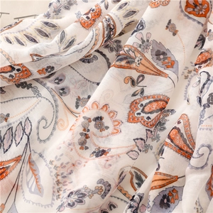 Detailed close-up of paisley print on soft cotton linen scarf with breathable texture