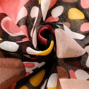 Macro detail of soft cotton-linen scarf showing vibrant dots and breathable fabric texture