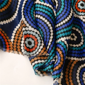 Detail of bohemian kaleidoscopic circle print on soft cotton-linen fabric scarf with frayed edges