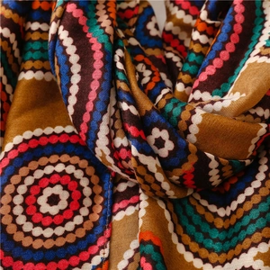 Macro shot of bohemian geometric scarf with colorful polka dots and fine fabric texture