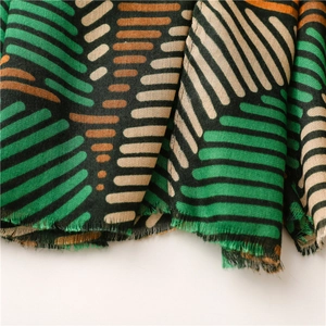 Detail of color-block striped scarf with geometric patterns and fringe edges