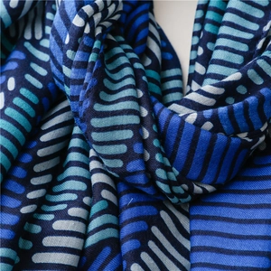 Macro shot of striped cotton linen scarf fabric with blue geometric abstract print