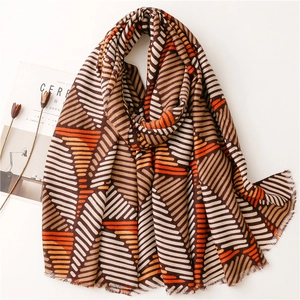 Soft cotton-linen scarf with geometric stripes and fringe detail in brown and orange