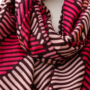 Detailed view of colorful striped scarf with soft fabric texture and pleated layers