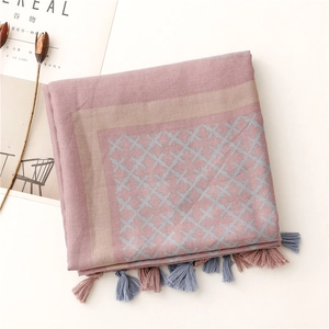 Close-up of pink and blue plaid linen scarf with delicate hand-knotted tassel fringes