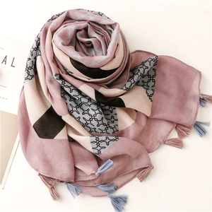 Detail of pink plaid cotton linen scarf with geometric patchwork and handmade tassels