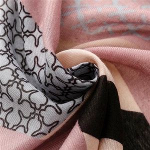 Macro detail of plaid pattern scarf with soft pink geometric blocks and fringed weave