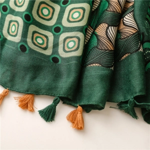 Detail view of paisley print scarf with dual-tone woven tassels and cotton-linen texture