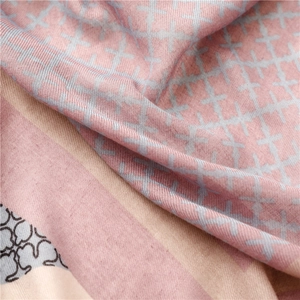 Detailed macro view of pink cotton linen scarf featuring cross pattern and soft texture