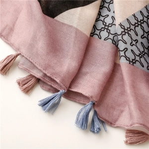 Macro shot of geometric pink and black scarf with fine weave and handmade tassels