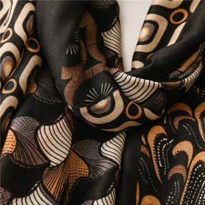 Detail of pashmina scarf featuring black cashew paisley and geometric patterns in soft twill
