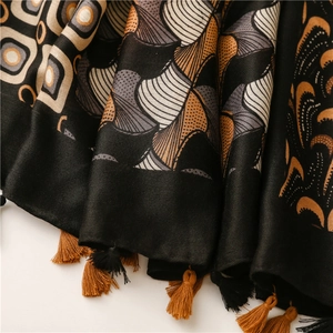Close-up of vintage paisley print scarf with silky texture and elegant fringe tassels