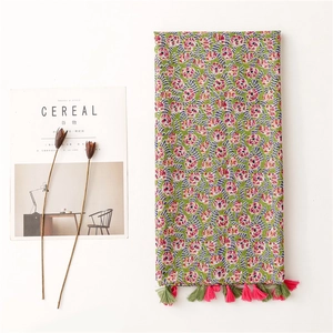 Floral cotton linen scarf with colorful branch patterns and tassel trim on white background