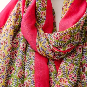 Close-up of floral print cotton linen scarf with tassels and colorful branch patterns