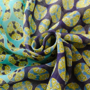 Detail of light cotton linen scarf showing abstract oval patterns and soft texture
