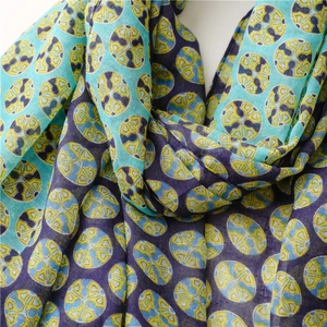 Close-up of cotton linen scarf showing geometric circle prints and woven fabric texture
