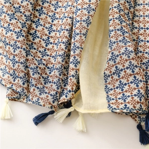 Detail of geometric pattern scarf with cotton-linen feel and bicolor fringe tassels